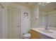 Bathroom with a neutral color palette with a door to the left and a vanity and mirror to the right at 4425 Corso Venetia Blvd # A20, Venice, FL 34293