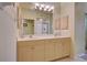 Bathroom with double sinks and vanities and walk-in shower and toilet at 4425 Corso Venetia Blvd # A20, Venice, FL 34293