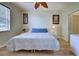 Comfortable bedroom with natural light, fan, and neutral walls and flooring at 4425 Corso Venetia Blvd # A20, Venice, FL 34293