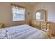 Bedroom features a double bed with soft-colored linens and a matching dresser and mirror set at 4425 Corso Venetia Blvd # A20, Venice, FL 34293