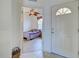 Bedroom view through the entryway with a ceiling fan and an arched front door at the front of the shot at 4425 Corso Venetia Blvd # A20, Venice, FL 34293