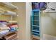 Organized closet featuring shelving with linens and a hanging organizer for optimal storage solutions at 4425 Corso Venetia Blvd # A20, Venice, FL 34293