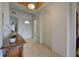 Inviting entrance featuring tile flooring, arched doorways, and a decorative table at 4425 Corso Venetia Blvd # A20, Venice, FL 34293