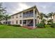 Beautiful exterior view with screened patio and lush greenery and lawn surrounding the townhouse at 4425 Corso Venetia Blvd # A20, Venice, FL 34293