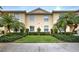 Charming townhouse featuring well-manicured lawn and lush landscaping with mature palm trees at 4425 Corso Venetia Blvd # A20, Venice, FL 34293