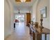 Inviting hallway with tile flooring and views of the living room and outdoor seating area at 4425 Corso Venetia Blvd # A20, Venice, FL 34293
