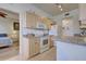 Cozy kitchen featuring light wood cabinetry, appliances, and breakfast bar at 4425 Corso Venetia Blvd # A20, Venice, FL 34293