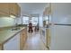 Open kitchen with wood cabinets, granite counters, and an adjacent dining area at 4425 Corso Venetia Blvd # A20, Venice, FL 34293