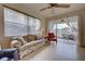 Comfortable living room with a ceiling fan, tile floors, and screened in patio access at 4425 Corso Venetia Blvd # A20, Venice, FL 34293