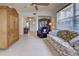 Cozy living room featuring tile flooring, comfortable seating, and a view into entry way at 4425 Corso Venetia Blvd # A20, Venice, FL 34293