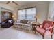 Cozy living room featuring tile flooring, comfortable seating, and natural light from the window at 4425 Corso Venetia Blvd # A20, Venice, FL 34293