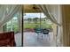 View of the covered lanai showing view of the lake and patio furniture at 4425 Corso Venetia Blvd # A20, Venice, FL 34293