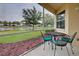 A view of the lake from the screened lanai with outdoor furniture at 4425 Corso Venetia Blvd # A20, Venice, FL 34293