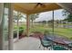 Screened lanai featuring a view of the lake, with a ceiling fan and outdoor seating at 4425 Corso Venetia Blvd # A20, Venice, FL 34293