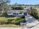 A charming one-story home with a well-manicured lawn, mature trees, and a welcoming curb appeal at 492 Constance Rd, Venice, FL 34293