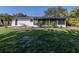 Back exterior showcasing a screened lanai and patio, perfect for outdoor entertaining at 492 Constance Rd, Venice, FL 34293