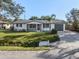 Well-maintained single-story home with a gray roof, attached garage, and manicured front lawn at 492 Constance Rd, Venice, FL 34293