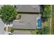 Aerial view of a home, featuring a screened in pool and landscaped yard in a well maintained community at 5194 Layton Dr, Venice, FL 34293