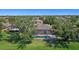 Aerial view of a home with a screened pool at 5194 Layton Dr, Venice, FL 34293