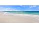 A pristine beach with clear blue water and soft white sand, inviting relaxation and coastal enjoyment at 5194 Layton Dr, Venice, FL 34293