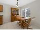 Cozy dining area with a wooden table, hutch, and natural light from the nearby window at 5194 Layton Dr, Venice, FL 34293