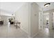 Inviting hallway with tile flooring leading to a bright living area and bedrooms at 5194 Layton Dr, Venice, FL 34293