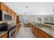 Open concept kitchen with stainless steel appliances, granite countertops, and tile flooring at 5194 Layton Dr, Venice, FL 34293
