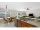 Open concept kitchen with granite counters, stainless steel appliances, breakfast nook and pool views at 5194 Layton Dr, Venice, FL 34293