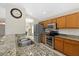 Kitchen with stainless appliances, double sinks, granite countertops, and wood cabinetry at 5194 Layton Dr, Venice, FL 34293