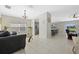 Open living room with tile flooring and views into the adjacent kitchen and dining area at 5194 Layton Dr, Venice, FL 34293