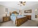Bright main bedroom with ceiling fan, decorative wall art, and light-colored carpet at 5194 Layton Dr, Venice, FL 34293