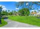 A gazebo with a park featuring a lawn, trees, sidewalks, and blue skies overhead at 5194 Layton Dr, Venice, FL 34293