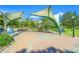 Outdoor pavilion in a park setting with a large shade structure over picnic tables and benches at 5194 Layton Dr, Venice, FL 34293