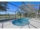 Inviting screened pool area overlooking a serene lake, perfect for relaxation and outdoor enjoyment at 5194 Layton Dr, Venice, FL 34293