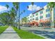Street view of a commercial building with restaurants, shops, palm trees, sidewalks, and cars parked along the street at 5194 Layton Dr, Venice, FL 34293