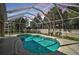 Inviting screened pool area with clear blue water, lush tropical landscaping, and plenty of privacy at 5255 Andris St, North Port, FL 34288