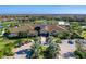 Aerial view of the community clubhouse with lush landscaping, paved parking, and manicured grounds at 5389 Trails Bend Ct, Sarasota, FL 34238