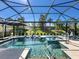 Luxurious in-ground pool and spa with screen enclosure and lounge chairs at 5389 Trails Bend Ct, Sarasota, FL 34238