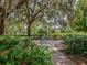 Peaceful community garden area with a swing bench and lush foliage creating a serene and inviting atmosphere at 5800 Niblick Pl, North Port, FL 34287