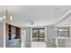 Open-concept living room with built-in shelving, a ceiling fan, and sliding glass doors to the yard at 5921 Wake Forest Run # 104, Bradenton, FL 34211