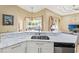 Kitchen island featuring marble countertops and stainless steel dishwasher at 6331 Mckinley Ter, Englewood, FL 34224