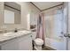 Bathroom with a vanity, toilet, and shower with a shower curtain and a shower head at 6665 Keystone Ct, North Port, FL 34287