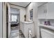 Bathroom featuring a white vanity, an open doorway, and wood-look flooring at 6665 Keystone Ct, North Port, FL 34287