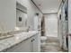 Bathroom featuring a white vanity, a framed mirror, and a walk-in shower at 6665 Keystone Ct, North Port, FL 34287