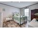 Bedroom featuring a metal bedframe, an accent chair, and natural light at 6665 Keystone Ct, North Port, FL 34287