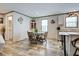 Cozy dining area featuring a glass table, wood-look flooring, and a built-in hutch at 6665 Keystone Ct, North Port, FL 34287