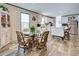 Bright kitchen with dining area, white cabinets, stainless steel refrigerator, and wood-look floors at 6665 Keystone Ct, North Port, FL 34287