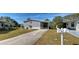 Charming gray home featuring well-maintained landscaping and a covered carport in a lovely community at 6665 Keystone Ct, North Port, FL 34287