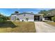Charming gray home featuring well-maintained landscaping and a covered carport in a lovely community at 6665 Keystone Ct, North Port, FL 34287