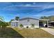 Charming gray home featuring well-maintained landscaping and a covered carport in a lovely community at 6665 Keystone Ct, North Port, FL 34287